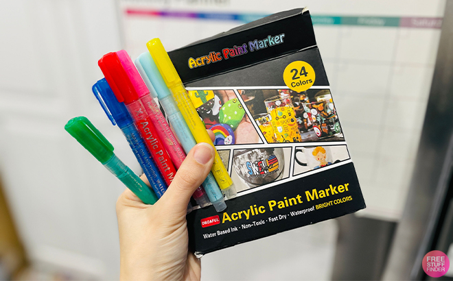 A Person Holding the Acrylic Paint Pens Markers 24 Colors Waterproof Paint Pens