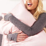 A Person Hugging a Pillow in a Pink Blissy Pillowcase
