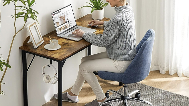 A Person Sitting on a Chair in Front of a 26 Inch Computer Desk A Person Sitting on a Chair in Front of a 26 Inch Computer Desk
