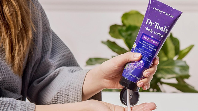 A Person Squeezing out Contents of Dr Teals Sleep Body Lotion on to her Palm