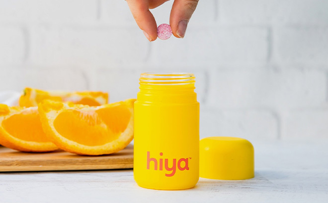 A Person Taking out a Vitamin out of a Hiya Box