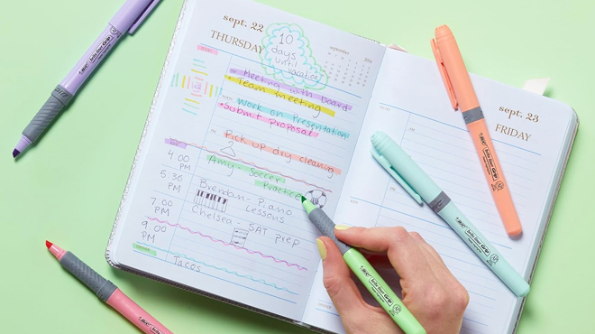 A Person Using BIC Brite Liner Grip Pastel Highlighters and Writing on a Notebook