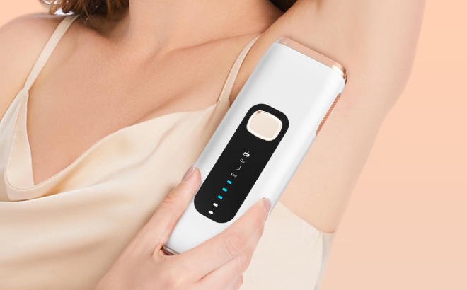 A Person Using IPL Laser Hair Removal Device on her Underarm