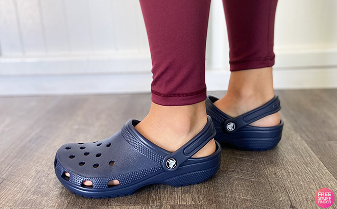 A Person Wearing Crocs Classic Clogs in Blue Color A Person Wearing Crocs Classic Clogs in Blue Color