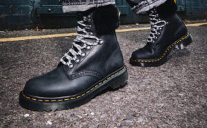 A Person Wearing Dr Martens Gender Inclusive 1460 Serena Faux Fur Lined Lug Sole Boots