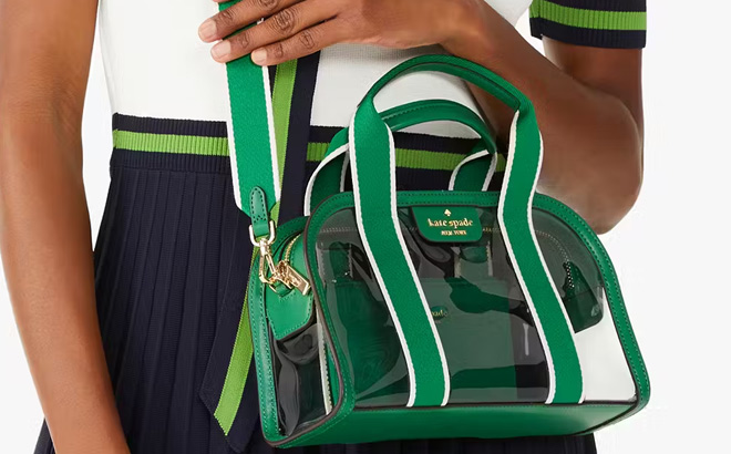 A Person Wearing Kate Spade Clare See Through Duffle Crossbody in Green Bean Color