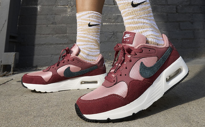A Person Wearing Nike Air Max SC SE Womens Shoes