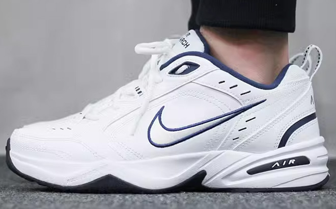 A Person Wearing Nike Air Monarch IV Mens Workout Shoes