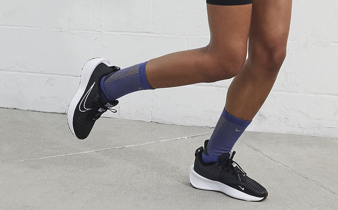 A Person Wearing Nike Interact Run Womens Road Running Shoes
