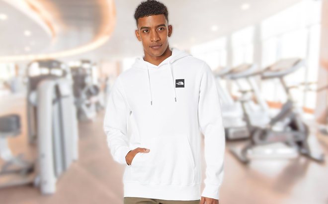 A Person Wearing The North Face Brand Proud White Hoodie Inside a Fitness Gym