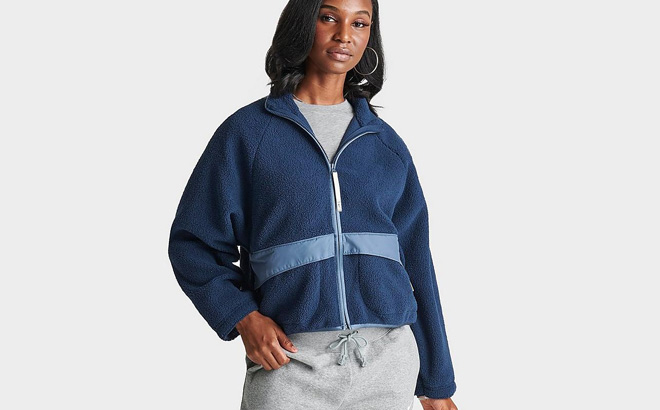 A Person Wearing Womens Nike Sportswear High Pile Sherpa Jacket in Diffused Blue Color