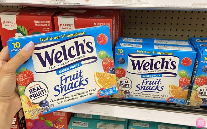 A Person holding a Box of Welchs Fruit Snacks
