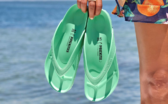 A Person Holding Birkenstock Womens Honolulu EVA Sandals in Bold Jade Color