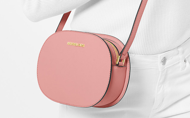 A Person is Holding Michael Kors Jet Set Travel Medium Saffiano Leather Crossbody Bag in Primrose Color