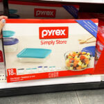 A Person is Holding Pyrex 18 Piece Glass Storage Set in a Store Aisle