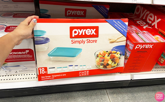 A Person is Holding Pyrex 18 Piece Glass Storage Set in a Store Aisle