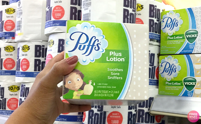 A Woman Holding Puffs 48 Count Plus Lotion Tissues