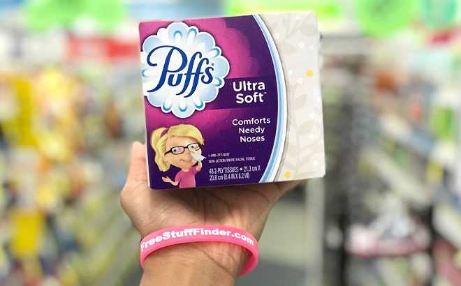 A Woman Holding Puffs 48 Count Ultra Soft Tissues