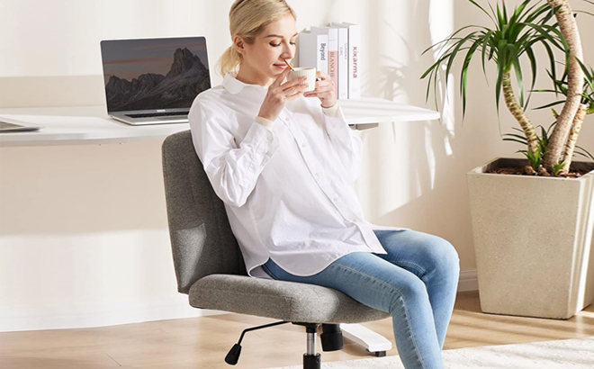 A Woman Sitting on Cross Legged Office Desk Chair