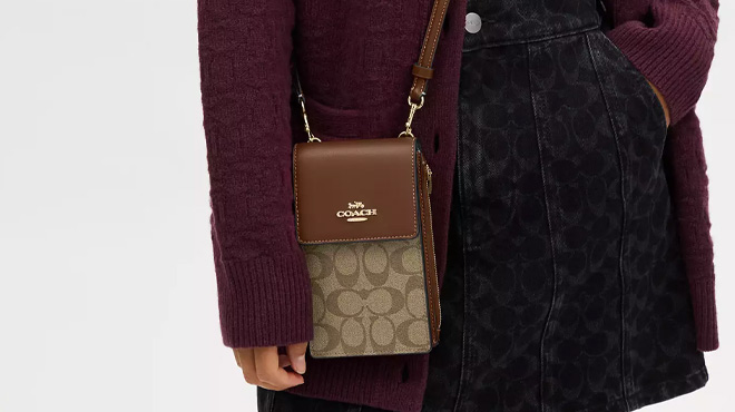 A Woman Wearing Coach Outlet North South Phone Crossbody In Signature Canvas