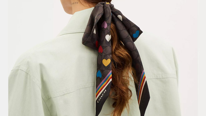 A Woman Wearing Coach Outlet Signature Love Print Silk Skinny Scarf