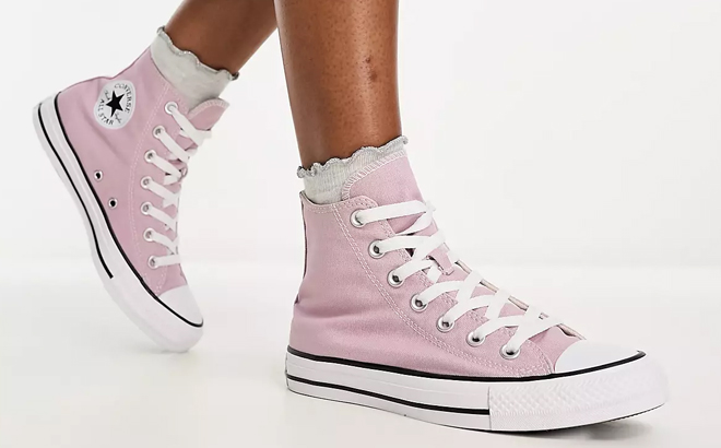 A Woman Wearing Converse Chuck Taylor All Star Hi Sneakers