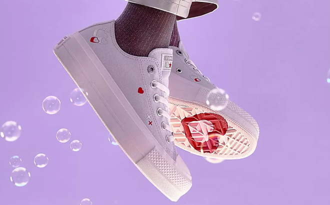 A Woman Wearing Converse Chuck Taylor All Star Sneakers with Heart Embroidery
