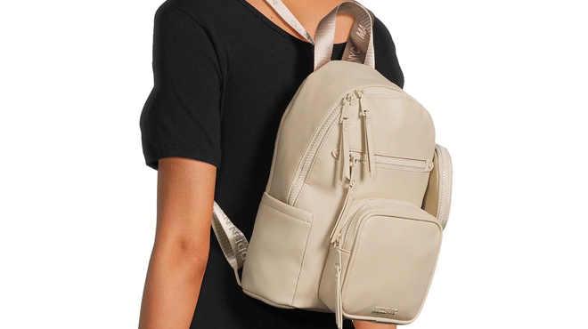 A Woman Wearing Madden NYC Womens Mini Backpack with Pouch in Khaki Color