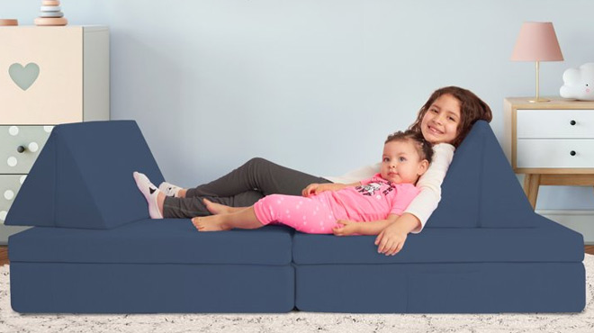 A kid and a toddler lounging on a Imaginarium Kids Play Couch in Navy blue color