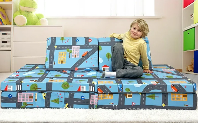 A kid lounging on a Road Map Designed Imaginarium Kids Play Couch