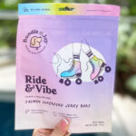 A person Holding a Bag of Bundle x Joy Ride Vibe Salmon Superfood Jerky Bars