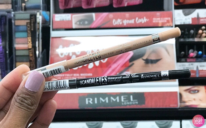A person holding Two Rimmel Eyeliners in different Shades
