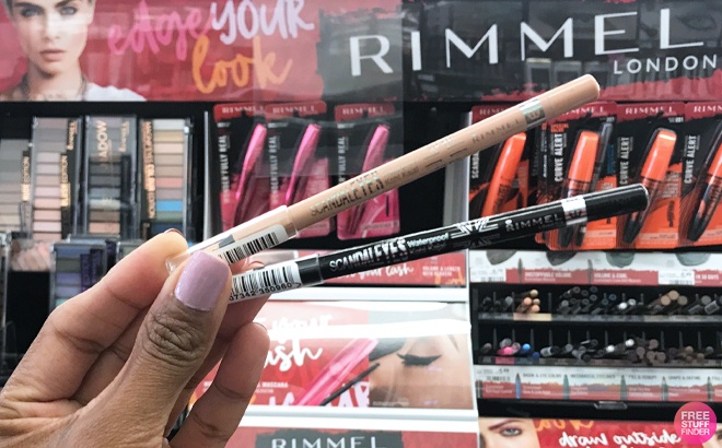 A person holding Two Rimmel Scandal Eyes Eyeliners in different Shades A person holding Two Rimmel Scandal Eyes Eyeliners in different Shades