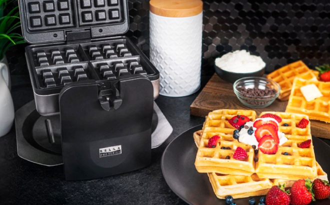 Bella Pro 4 Slice Rotating Waffle Maker with Cooked Waffled on a Plate