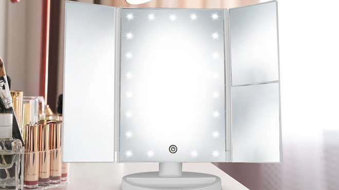 Deweisn Trifold Lighted Vanity Mirror in Silver on a Makeup Table