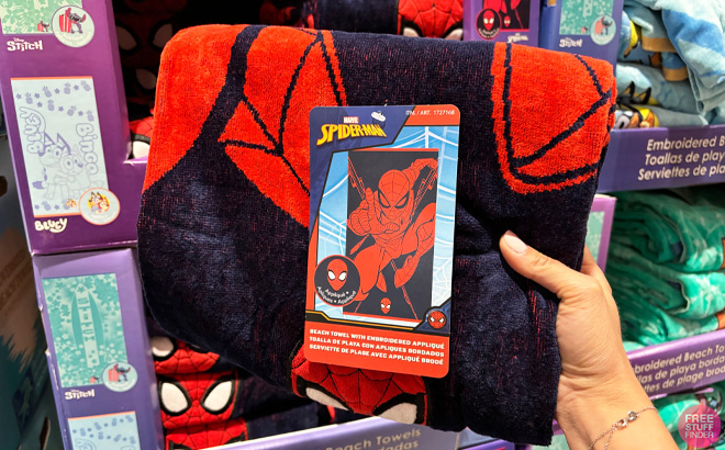 Hand Holding Spiderman Beach Towel at Costco