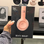 Hand holding Beats Solo3 Wireless On Ear Headphones Rose Gold