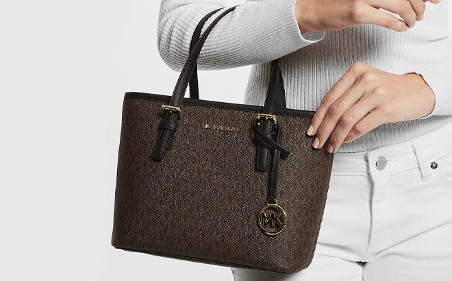 Lady holding Michael Kors Jet Set Travel Extra Small Logo Top Zip Tote Bag Lady holding Michael Kors Jet Set Travel Extra Small Logo Top Zip Tote Bag