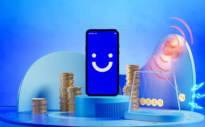 Mobile Phone with Visible on the Background next to Coins