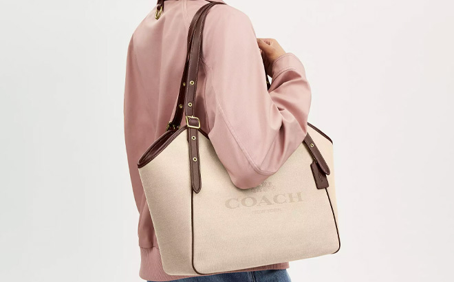Person Holding Coach Outlet Meadow Shoulder Bag