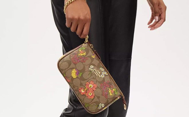 Person Holding Coach Outlet Nolita 19 In Signature Canvas With Floral Print
