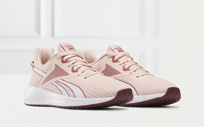 Reebok Lite Plus 3 Womens Shoes in Possibly Pink Color on the Table