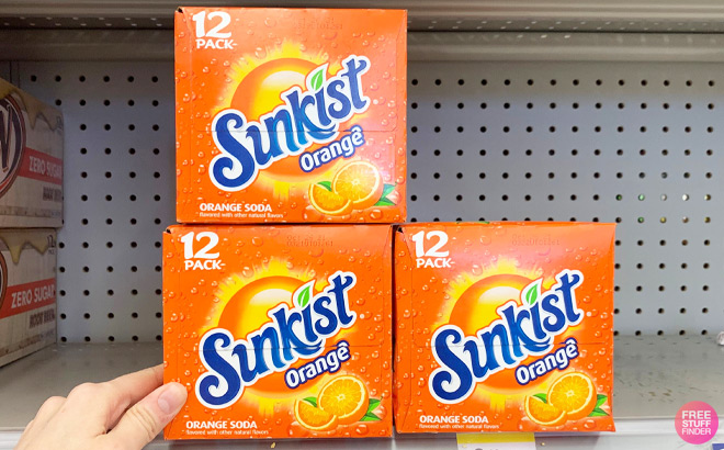 Three Sunkist Orange Soda 12 Packs on a Shelf