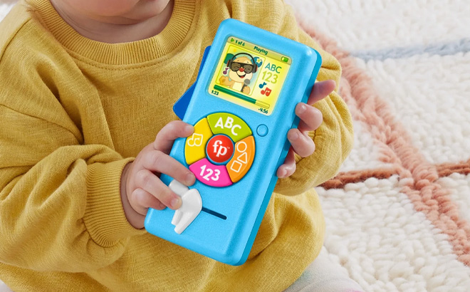 a Baby Holding Fisher Price Laugh Learn Music Player Learning Toy