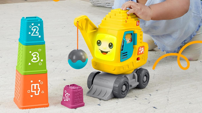 a Baby Playing with Fisher Price Crane with Blocks Learning Toy