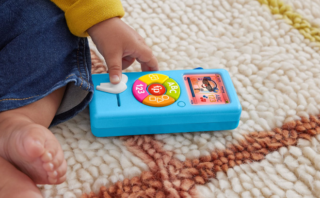 a Baby Pushing the Buttons on Fisher Price Laugh Learn Music Player Learning Toy