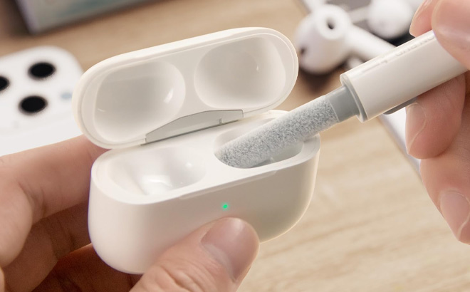 a Person Cleaning AirPods with Cleaner Kit
