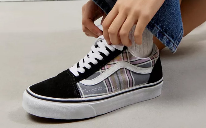 a Person Tying Laces on VANS Old Skool Plaid Sneakers a Person Tying Laces on VANS Old Skool Plaid Sneakers