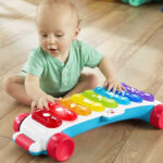 A Baby Playing with Fisher Price Giant Light Up Xylophone
