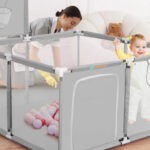 A Baby in a Portable Playpen with Basketball Hoop